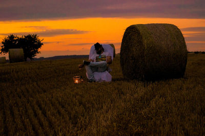 Scenic view of field against sky at sunset