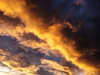 Low angle view of dramatic sky during sunset