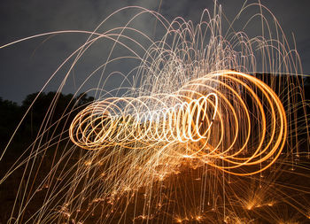 Illuminated light painting against sky at night