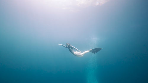 Low angle view of woman swimming underwater