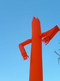 Low angle view of airplane flying against clear blue sky