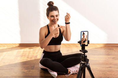 Full length of woman exercising in gym