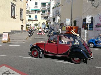 Vehicles on road against buildings in city