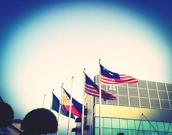 Low angle view of american flag against blue sky