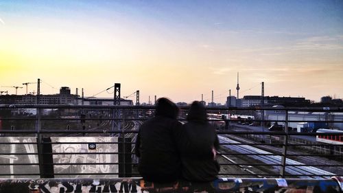 People walking in city at sunset