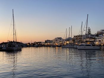 Sailboats in marina at sunset