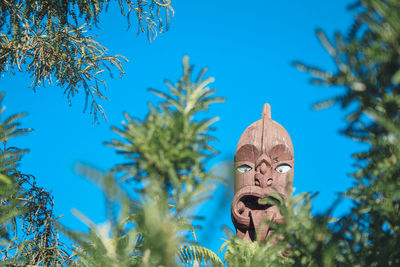 Low angle view of statue against blue sky