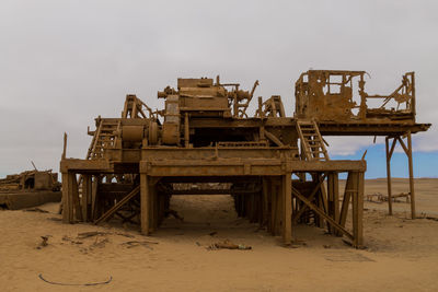 Construction site on beach against clear sky