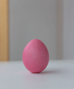 Close-up of pink apple on table