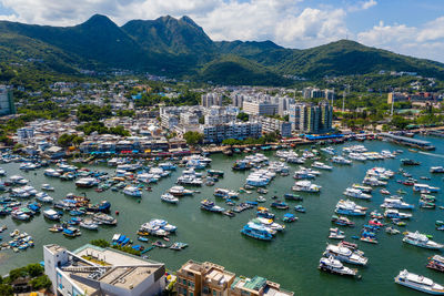 High angle view of boats moored at harbor in city