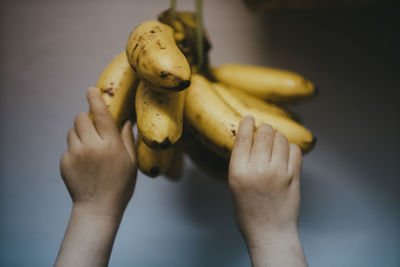 Close-up of hands holding bananas