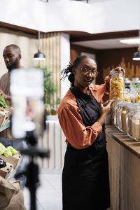 Side view of woman holding food at home