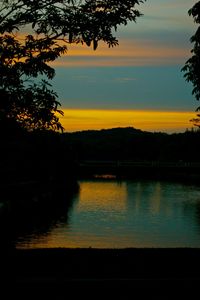 Scenic view of lake against sky at sunset