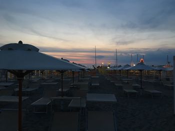 Scenic view of beach against sky at sunset