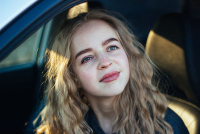 Portrait of beautiful woman in car