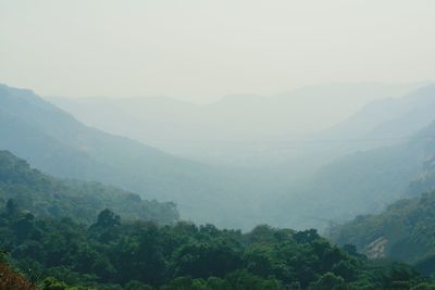 Scenic view of mountains against sky during foggy weather