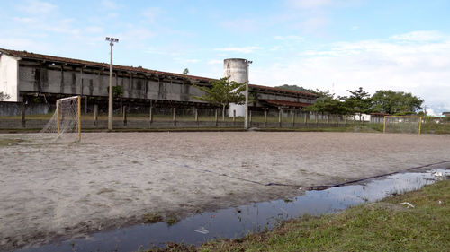 Built structure by water against sky