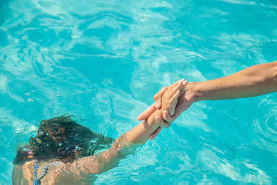 High angle view of people swimming in pool