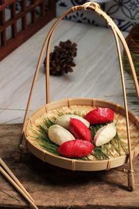 Red and white traditional chuseok day food, korean half moon shaped rice cake or songpyeon.