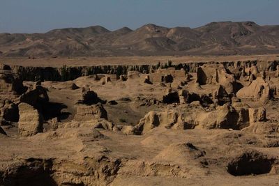 Scenic view of rock formations in desert against sky
