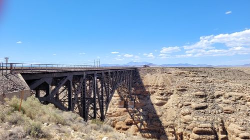 Arch bridge over land against sky