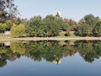 Reflection of trees in lake against sky