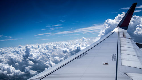 Aerial view of aircraft wing against sky