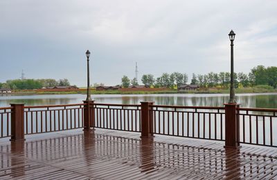 Street by lake against sky