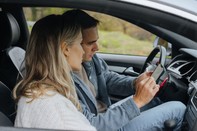 Rear view of woman sitting in car