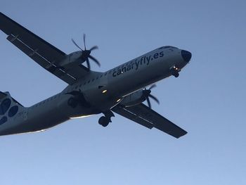 Low angle view of airplane against clear sky