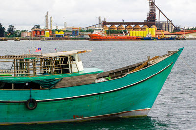 Boats moored in sea against sky