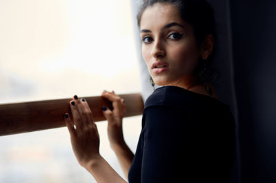 Portrait of young woman sitting outdoors