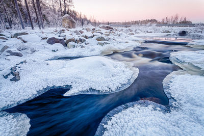 Close-up of frozen lake against sky during winter