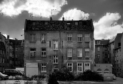 Buildings against cloudy sky