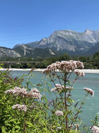 Scenic view of lake and mountains against clear sky