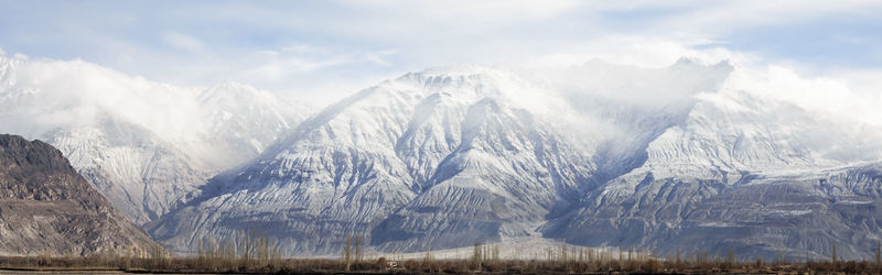 Panoramic shot of snowcapped mountains against sky