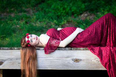 Woman lying down on wood