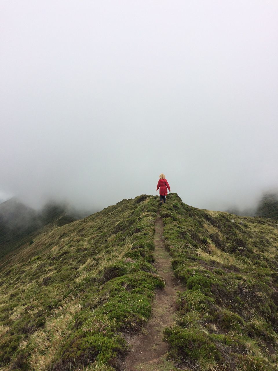 nature, mountain, walking, fog, hiking, beauty in nature, rear view, real people, adventure, landscape, scenics, outdoors, full length, tranquility, the way forward, tranquil scene, day, grass, lifestyles, one person, sky, slope, people