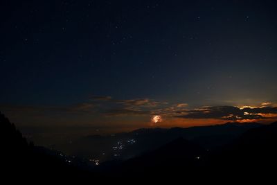 Scenic view of silhouette mountain against sky at night