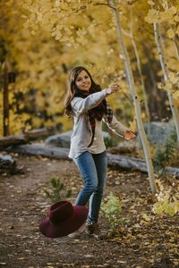 Portrait of smiling girl standing by tree