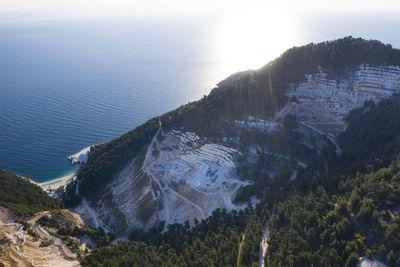 High angle view of sea and trees against sky