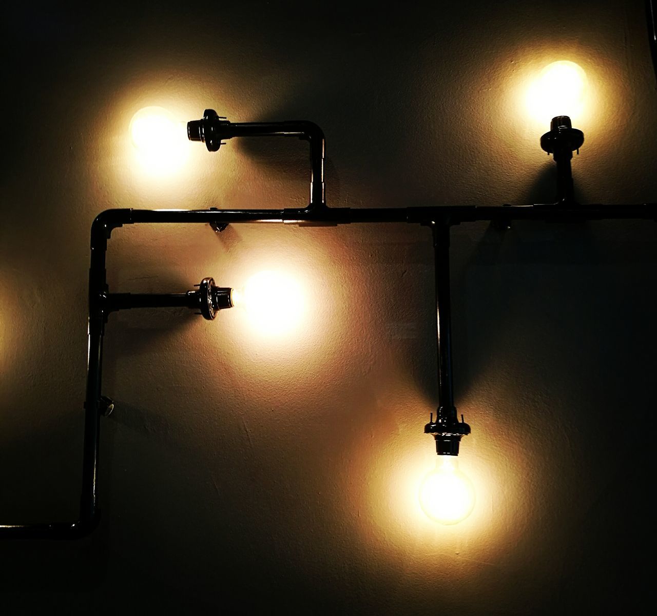 lighting equipment, illuminated, indoors, electricity, electric lamp, electric light, lamp, low angle view, ceiling, light - natural phenomenon, wall - building feature, hanging, glowing, light bulb, street light, home interior, technology, no people, light fixture, built structure