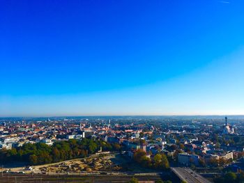 High angle shot of townscape against blue sky