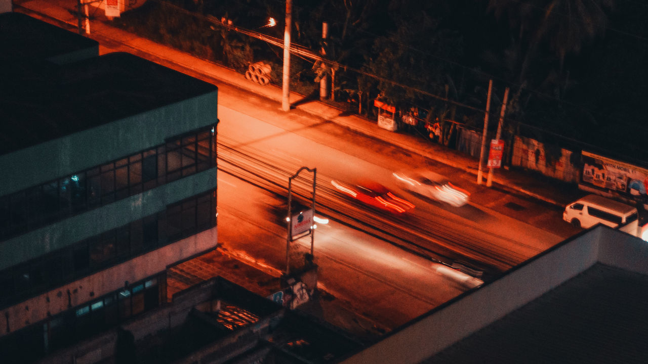 HIGH ANGLE VIEW OF LIGHT TRAILS ON ROAD IN CITY