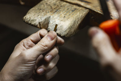 Cropped hand of person cutting board