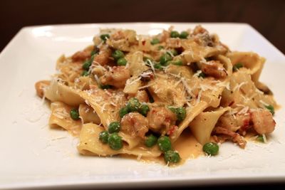 Close-up of pasta with wooden spoon in plate