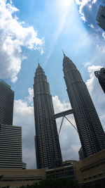 Low angle view of buildings against cloudy sky