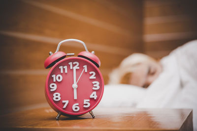 Close-up of a boy sleeping on table