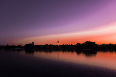 Scenic view of lake against romantic sky at sunset