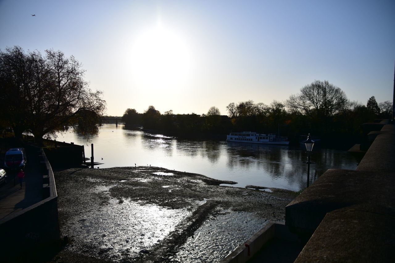 water, tree, sky, nature, plant, sunlight, reflection, lake, tranquility, sun, no people, beauty in nature, scenics - nature, tranquil scene, transportation, day, outdoors, silhouette, lens flare